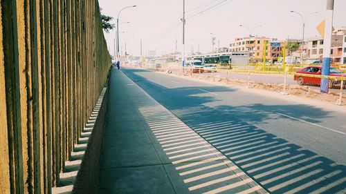 Vehicles on road against buildings in city