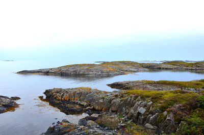 Rocks on beach against sky
