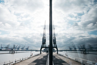 View of suspension bridge against cloudy sky