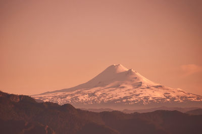 Scenic view of snowcapped mountains against sky during sunset