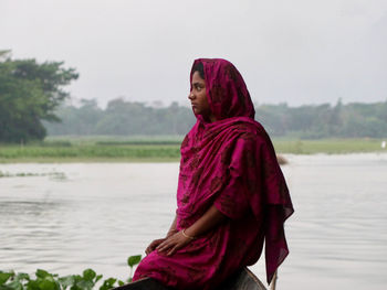 Portrait of a woman sitting on the edge of the boat