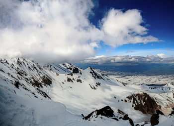 Scenic view of snow covered mountains against sky
