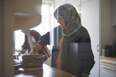 Woman in headscarf cooking together for eid al-fitr at home