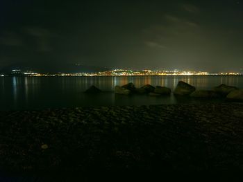 Scenic view of lake against sky at night