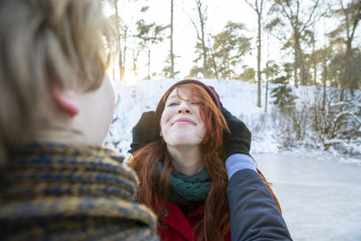 Smiling girlfriend enjoying weekend with boyfriend during winter