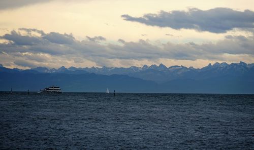 Scenic view of sea and mountains against sky during sunset