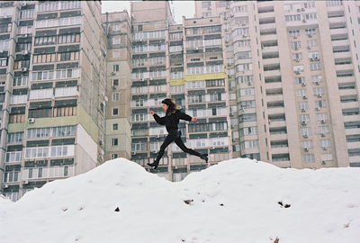 Woman in snow covered city in winter