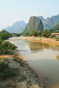 Scenic view of lake and mountains against clear sky