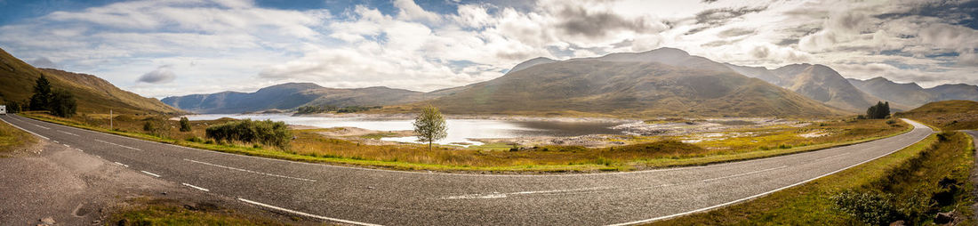 Empty road with mountain range in background