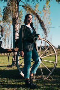 Portrait of young woman standing on field