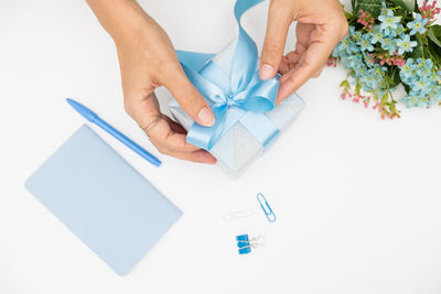 High angle view of woman hand holding white paper