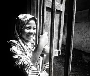 Portrait of a smiling young woman standing outdoors