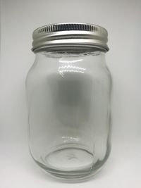 Close-up of jar over white background