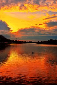 Scenic view of lake against orange sky