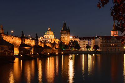 River with illuminated buildings in background at night