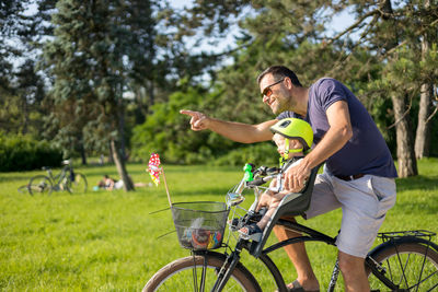 Man riding bicycle on field