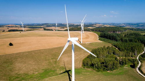 Windmill on field against sky