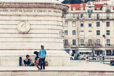 People walking on building in city