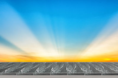 Scenic view of snow against sky during sunset