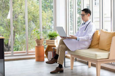 Man sitting on chair at home
