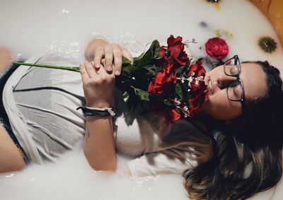 Woman lying down in bathtub