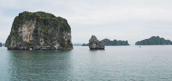 Scenic view of rock formation in sea against sky