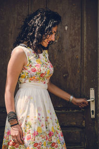 Midsection of woman holding umbrella standing outdoors