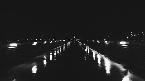 Reflection of illuminated lights in puddle