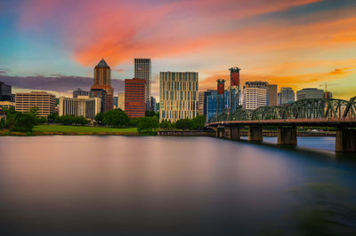 Bridge over river against sky during sunset