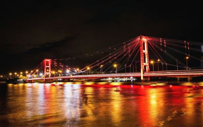 Illuminated suspension bridge at night