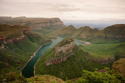 Scenic view of landscape and river against sky