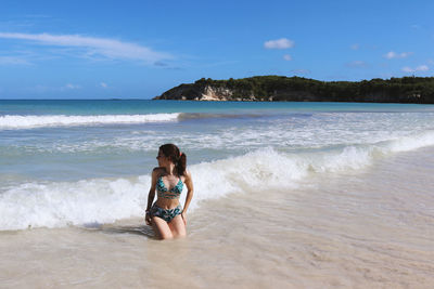 Woman on beach against sky