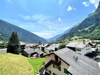 Houses on mountain against sky