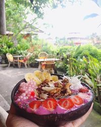 Close-up of hand holding food on table