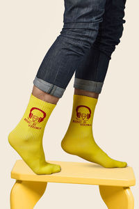 Low section of person standing against yellow background