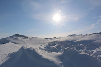 Scenic view of snow covered mountains against sky