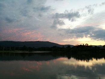 Scenic view of lake against sky at sunset