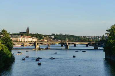 Bridge over river in city against sky