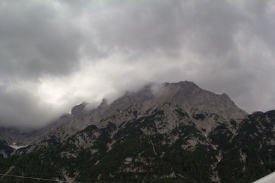 Scenic view of mountains against cloudy sky