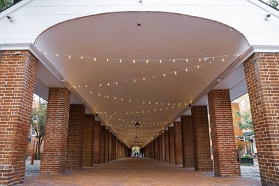 Low angle view of illuminated lights hanging on ceiling