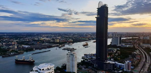 High angle view of city buildings against sky during sunset