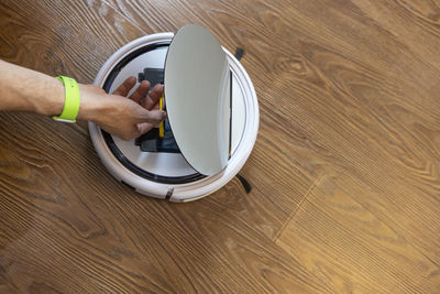 High angle view of man using mobile phone on hardwood floor