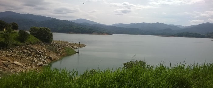 Scenic view of lake and mountains against sky