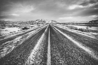 Surface level of road on field against sky