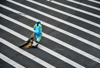 High angle view of man crossing road