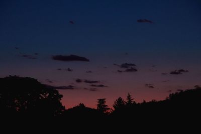 Low angle view of silhouette trees against sky at sunset