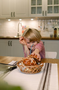 Boy with dessert on dining table at home
