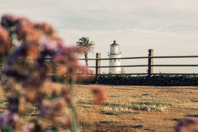 Tower on field against sky