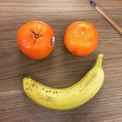 Oranges and banana on wooden table