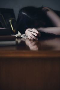 Midsection of woman sitting on table